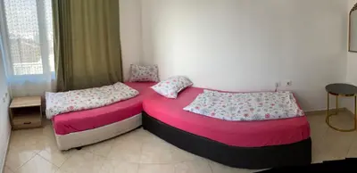 two beds in a bedroom with pink sheets at Casa De Zambini in Plovdiv