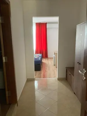 a room with a couch and a red curtain at Casa De Zambini in Plovdiv