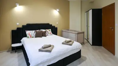 a bedroom with a large bed with towels on it at Студио Young Gogh in Pamporovo