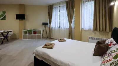 a hotel room with a bed with towels on it at Студио Young Gogh in Pamporovo