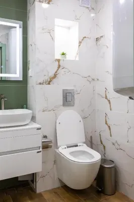 a white bathroom with a toilet and a sink at Evergreen 301 - Luxury ski apartment near gondola in Bansko