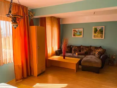 a living room with a couch and a table at Villa Madera - Spacious House with Swimming Pool, Sauna and Pool Table in Saparewo