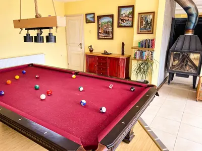 a pool table with balls on it in a living room at Villa Madera - Spacious House with Swimming Pool, Sauna and Pool Table in Saparewo