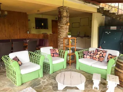 a group of chairs and a table in a room at Villa Madera - Spacious House with Swimming Pool, Sauna and Pool Table in Saparewo
