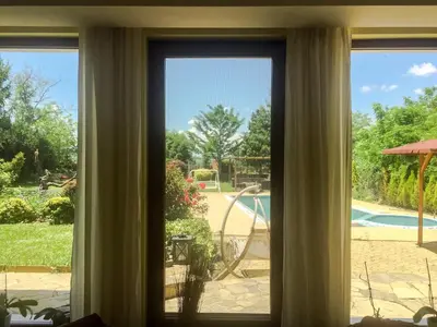 a window with a view of a pool at Villa Madera - Spacious House with Swimming Pool, Sauna and Pool Table in Saparewo