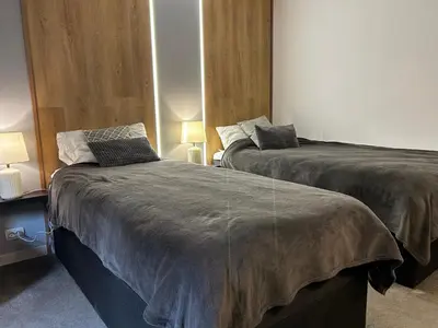 two beds sitting next to each other in a room at Devonshire Lodge Chalet in Bansko
