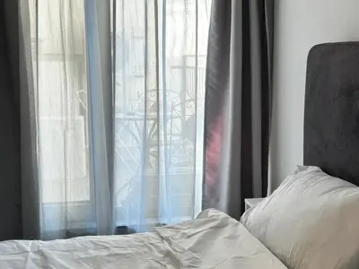 a bedroom with a bed and a window at Diamond Apartment in Plovdiv
