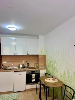 a kitchen with a table and a table and chairs at Flat F6 Bansko Rentals in Bansko
