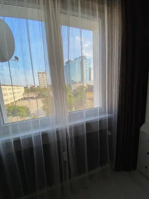 a room with two windows with a view of a city at Apartment PS in Sofia