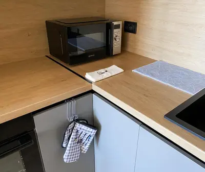 a microwave oven sitting on top of a kitchen counter at ELDORA Deluxe Private Apartment in Bansko