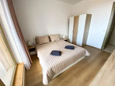 a bedroom with a bed with two blue towels on it at ELDORA Deluxe Private Apartment in Bansko