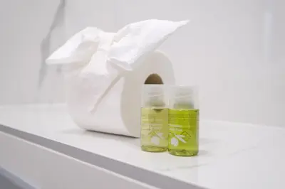 two bottles of essential oils on a shelf next to a white bag at Comfort 1 Bedroom App in Plovdiv