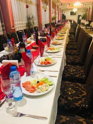 a long table with plates of food on it at Hotel Paradise in Ognyanovo