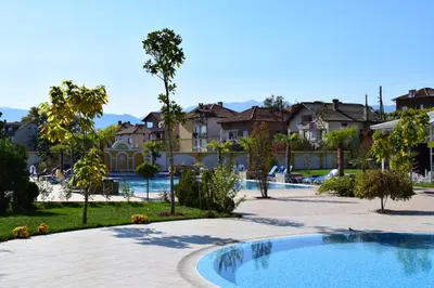a resort with a swimming pool and some houses at Hotel Paradise in Ognyanovo