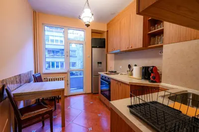 a kitchen with a table and a counter top at Cozy Central Apartment By NDK and Vitosha Blvd with Free secured parking and two terraces in Sofia