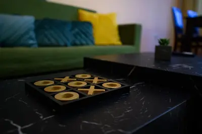 a black table with a box of donuts on it at Cozy Central Apartment By NDK and Vitosha Blvd with Free secured parking and two terraces in Sofia