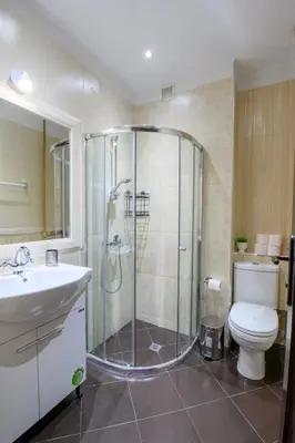 a bathroom with a shower and a toilet and a sink at Cozy Central Apartment By NDK and Vitosha Blvd with Free secured parking and two terraces in Sofia