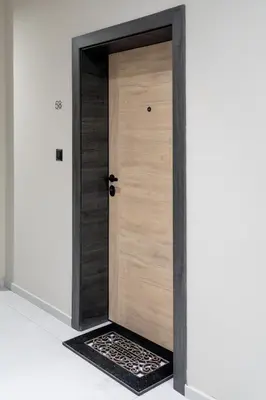 a wooden door in a room with a rug at Beni Deluxe in Plovdiv