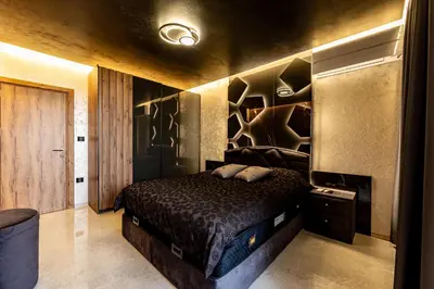 a bedroom with a bed in a room with a wall at Beni Deluxe in Plovdiv