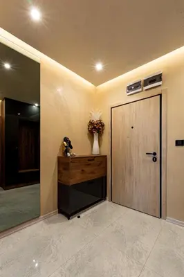 a hallway with a door and a vase of flowers at Beni Deluxe in Plovdiv
