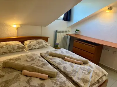 two beds in a bedroom with two towels on them at Prime Center - 1BDR Apt - Top Floor Next to the National Stadium & Sofia University in Sofia