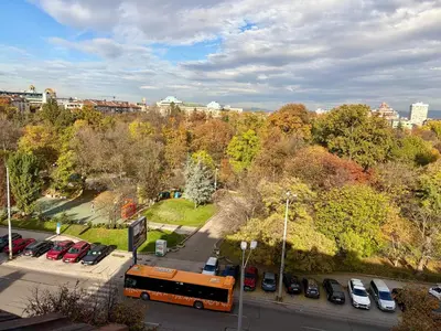 a bus parked in a parking lot in a city at Prime Center - 1BDR Apt - Top Floor Next to the National Stadium & Sofia University in Sofia