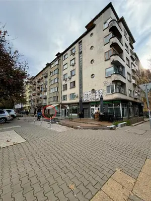 a large apartment building on a city street at Prime Center - 1BDR Apt - Top Floor Next to the National Stadium & Sofia University in Sofia