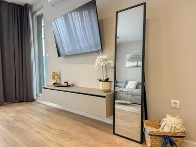 a mirror in a living room with a couch at 2BR Apartment in a Modern Complex with free Street Parking in Plovdiv
