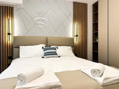 a bedroom with a bed with towels on it at 2BR Apartment in a Modern Complex with free Street Parking in Plovdiv