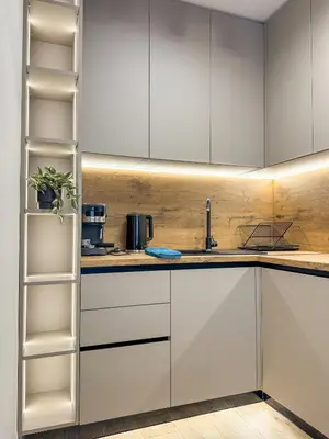 a kitchen with white cabinets and a shelf at 2BR Apartment in a Modern Complex with free Street Parking in Plovdiv