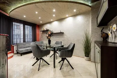 a living room with a table and chairs and a couch at Beni Deluxe 1 in Plovdiv