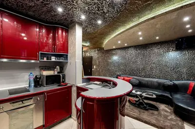 a kitchen with red cabinets and a counter top at Beni Deluxe 1 in Plovdiv