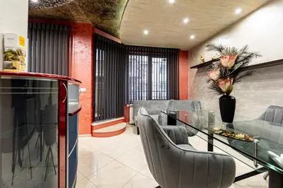 a living room with a glass table and chairs at Beni Deluxe 1 in Plovdiv