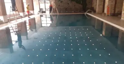 a swimming pool with lights in the floor of a building at СПА апартамент 