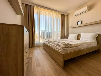 a bedroom with a bed and a large window at Quiet & Comfortable Urban Retreat in Sofia