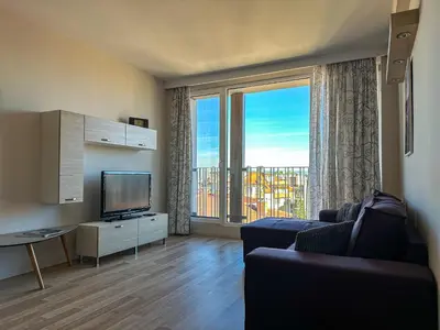 a living room with a couch and a large window at Quiet & Comfortable Urban Retreat in Sofia