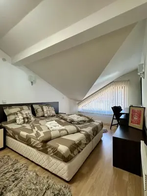 a bedroom with a large bed in a attic at Alpine Apartment Home2Host in Bansko