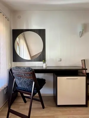 a dressing table with a chair and a mirror at Alpine Apartment Home2Host in Bansko