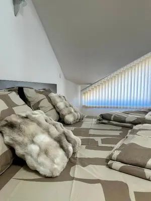 a room with several pillows on the floor at Alpine Apartment Home2Host in Bansko