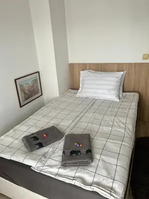 a bedroom with a bed with two pillows on it at Cozy apartment Alba with two bedrooms! in Blagoevgrad