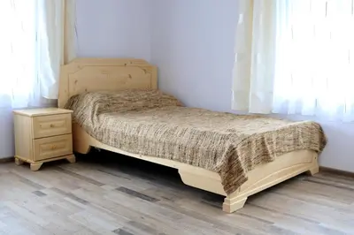 a bedroom with a wooden bed and a night stand at Къща за гости 