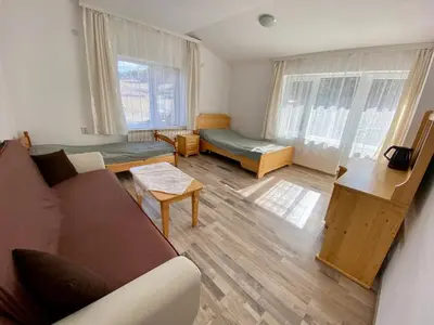 a living room with a couch and a table at Къща за гости 
