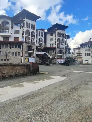 an empty parking lot in front of two tall buildings at The Monastery 3 1B9-Mанастира 3 1Б9 in Pamporovo