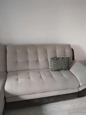 a white leather couch with two pillows on it at Apartment With Free Parking - Center Plovdiv in Plovdiv