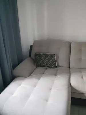 a white couch with a pillow sitting on it at Apartment With Free Parking - Center Plovdiv in Plovdiv