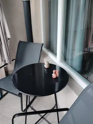 a black table and chair in a room with a window at Apartment With Free Parking - Center Plovdiv in Plovdiv