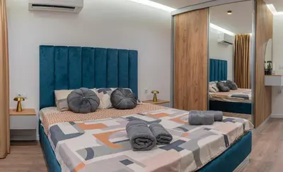 a bedroom with a large bed with pillows on it at Luxury & Modern Apartment - Rowing Canal Plovdiv in Plovdiv