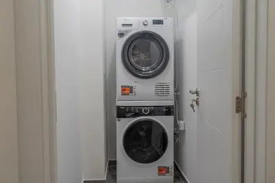 a washing machine and a dryer in a room at Luxury & Modern Apartment - Rowing Canal Plovdiv in Plovdiv