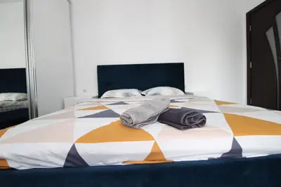 a bedroom with a bed with towels on it at Modern 1BR Apartment Plovdiv City Center Parking in Plovdiv