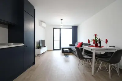 a living room with a white table and chairs at Modern 1BR Apartment Plovdiv City Center Parking in Plovdiv